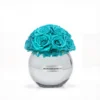 Clear glass Minoan Homey vase with turquoise artificial roses, minimalist flower arrangement