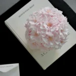 Delicate pink hydrangea bouquet on open cream-colored book titled Northern Lights