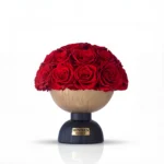 Wooden Minoan Homey vase with red roses, textured floral arrangement