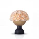 Matte gold spherical vase with peach roses, sophisticated floral design